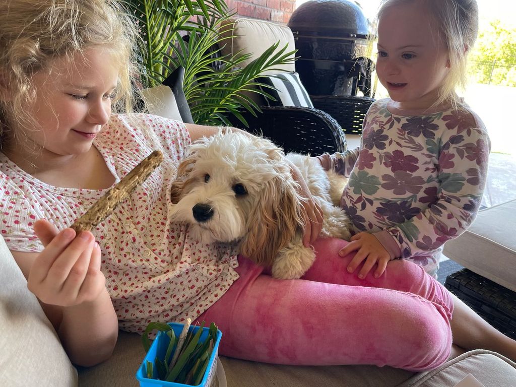 Two girls with their puppy
